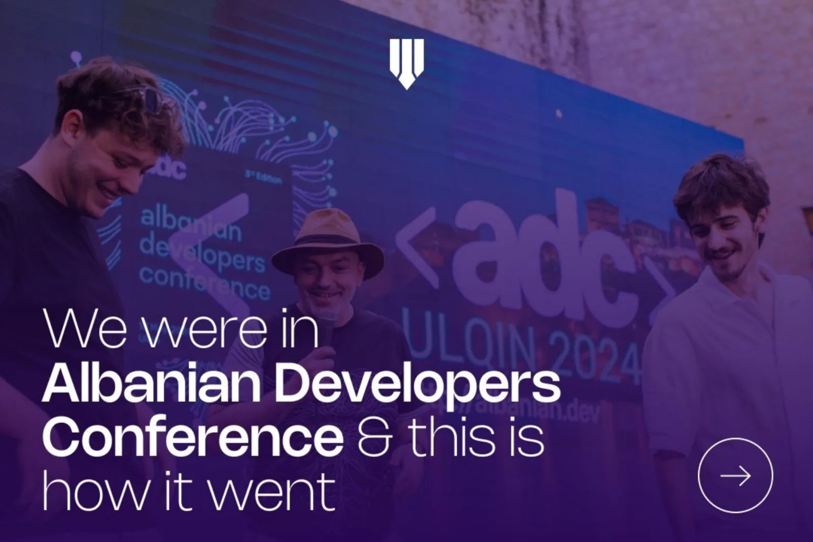 Brigada at the Albanian Developers Conference, Ulqin 2024, in front of the ADC stage screen.