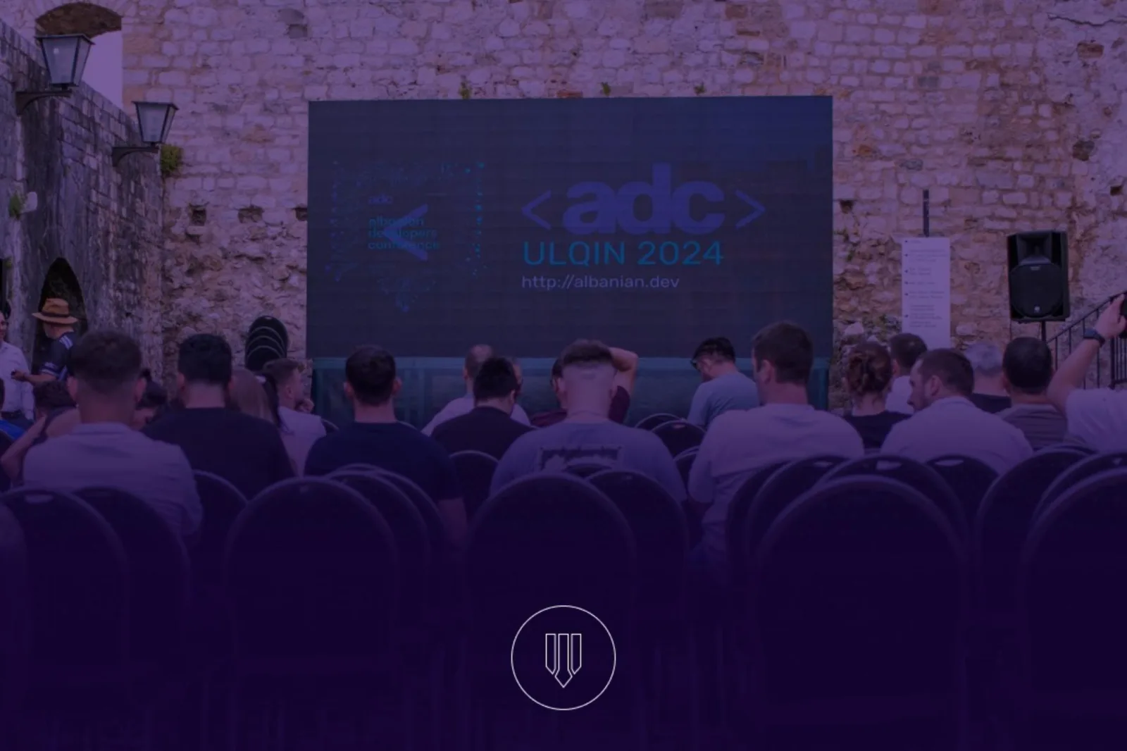 The ADC Ulqin 2024 audience seated in front of the stage inside the old fortress at Ulqin.